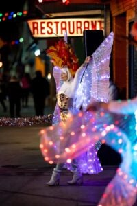 Maria Nehring of Fluidity Performance performing in LED wings